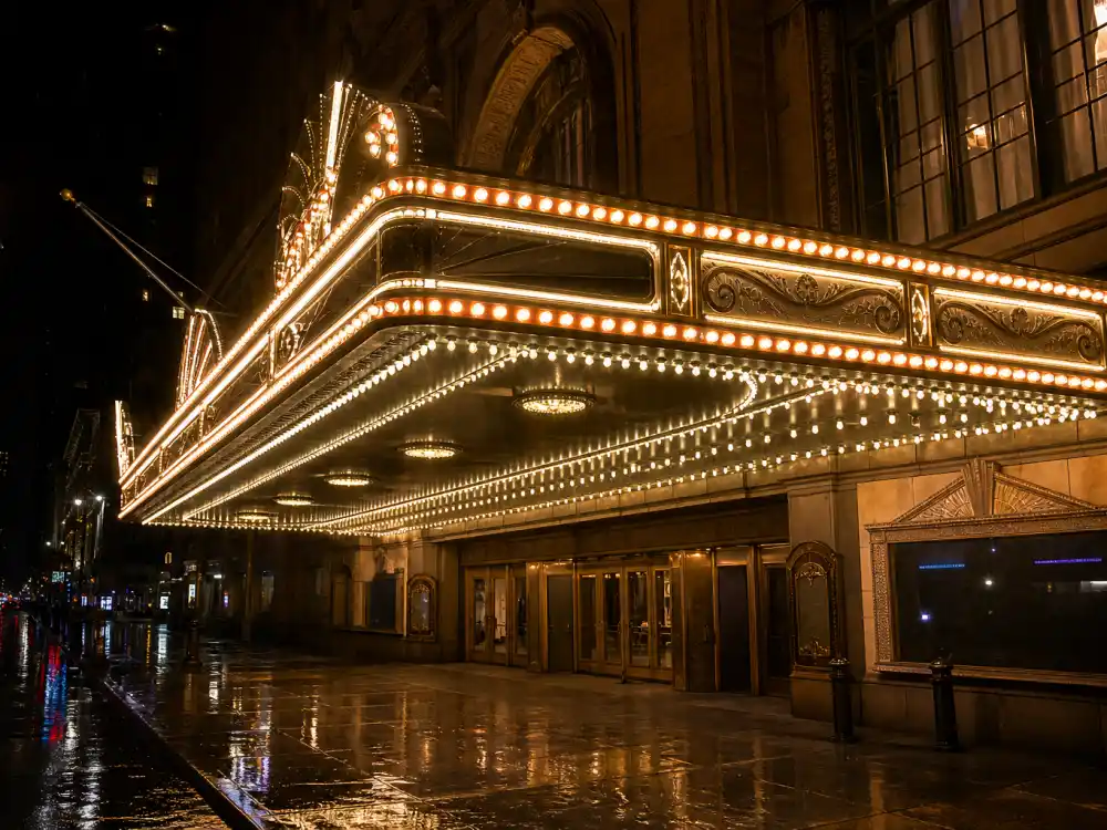 Broadway theater marquee illuminated at night where Ariana Grande ex-boyfriends story intersects with her Wicked career