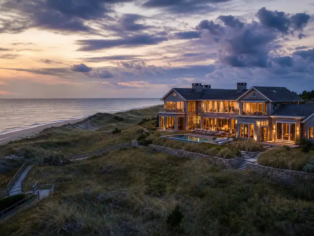 Hamptons beachfront shingle-style Beyonce house at dusk