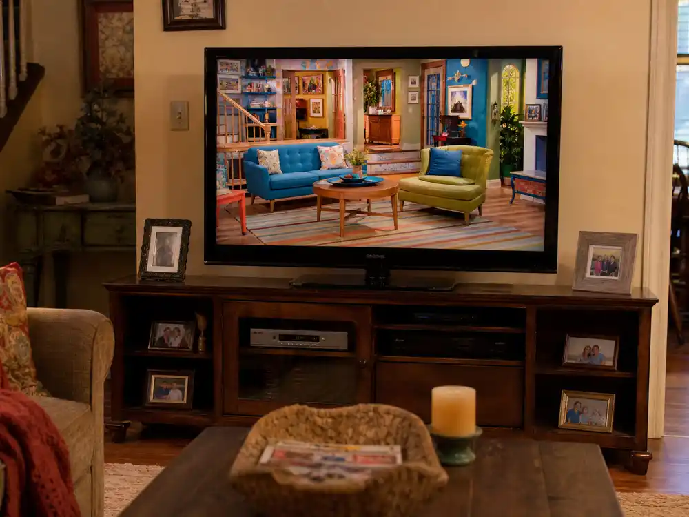 Bradley Steven Perry Disney Channel sitcom Good Luck Charlie set displayed on living room TV with family photos