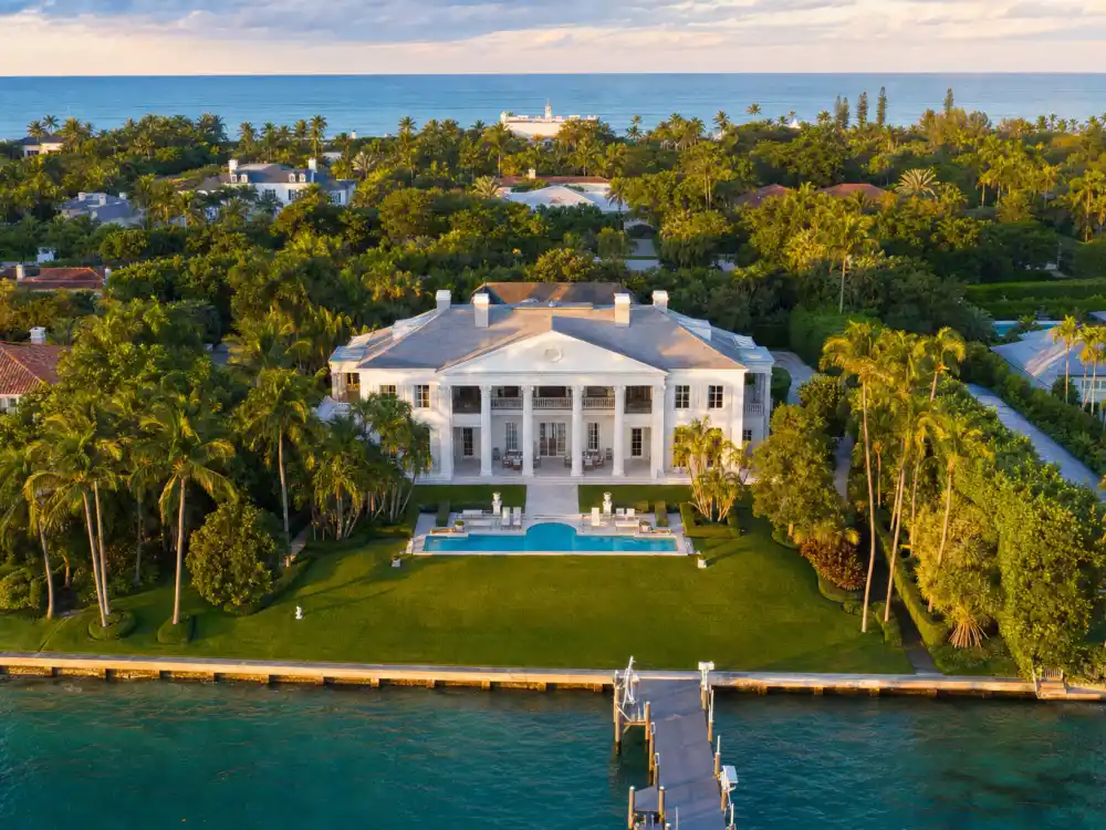 Aerial view of grand Palm Beach Florida oceanfront colonial mansion among the new homes of celebrities who left California
