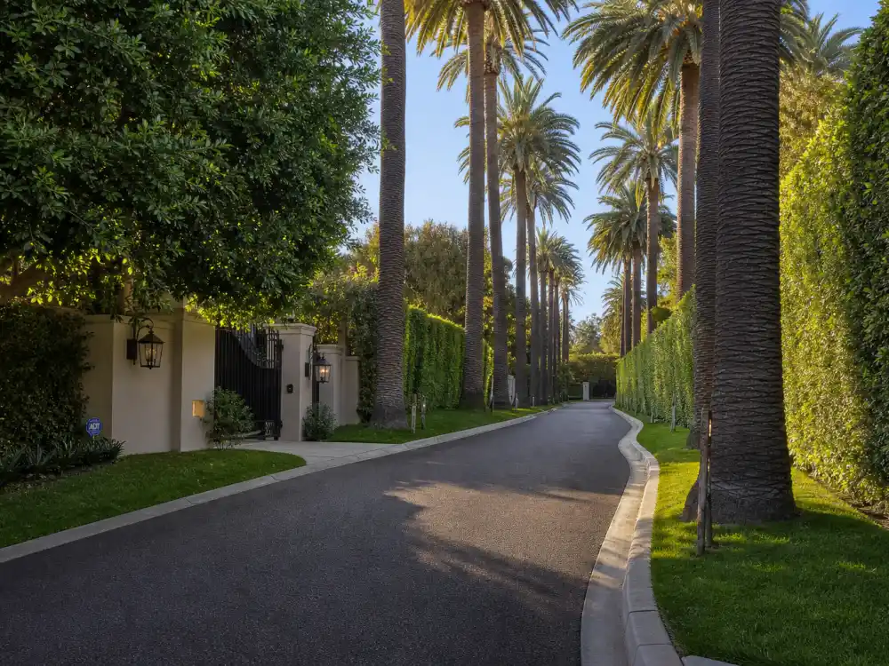 Curving palm-lined private street where celebrities who live in Bel Air keep their estates set behind hedges