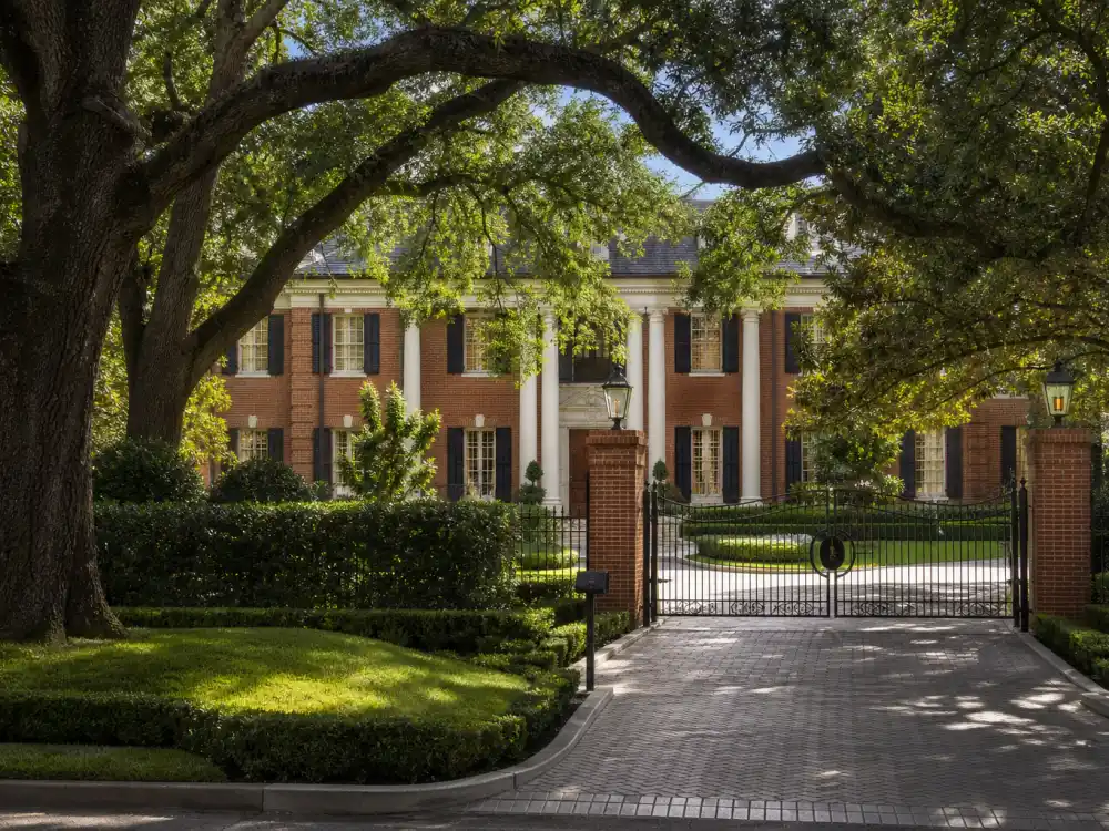River Oaks Houston grand colonial mansion with manicured lawns among the homes of the celebrities who moved to Texas