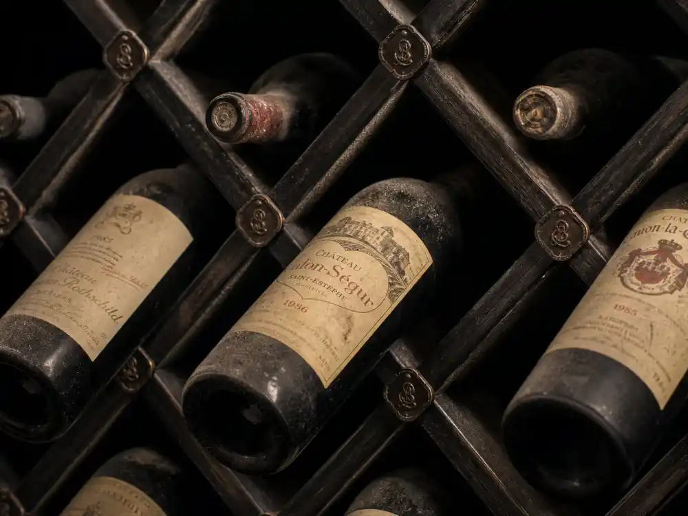 Antique dusty vintage bottles in private cellar from celebrities with wine cellars