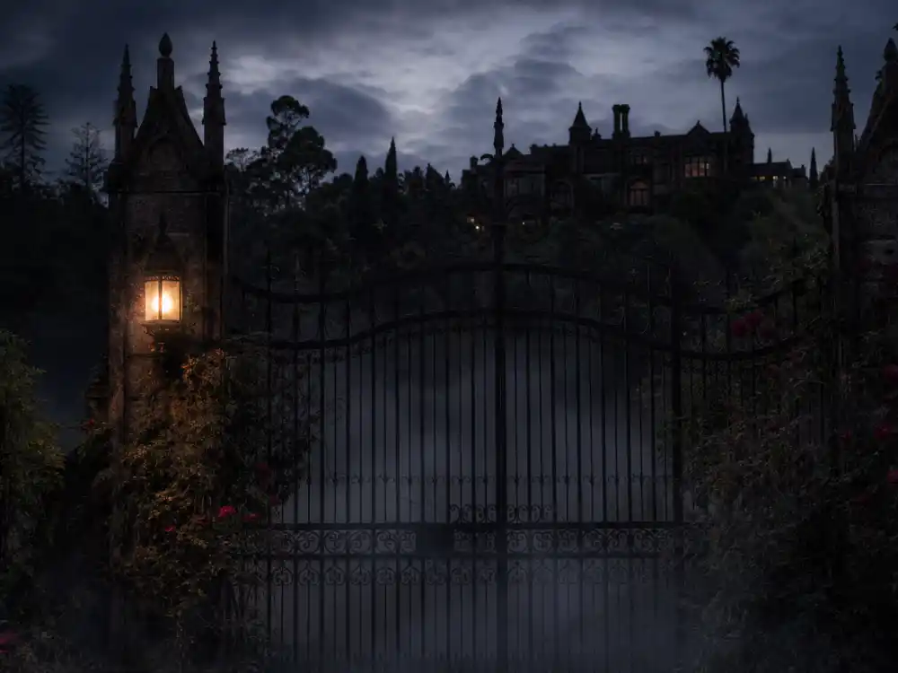 Gothic iron gate with fog at twilight from celebrity haunted houses