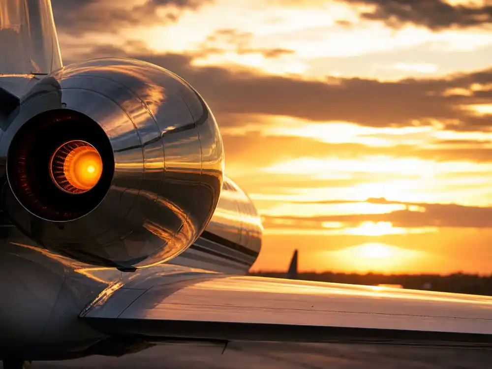 Engine close-up of celebrity private jets reflecting golden sunset light