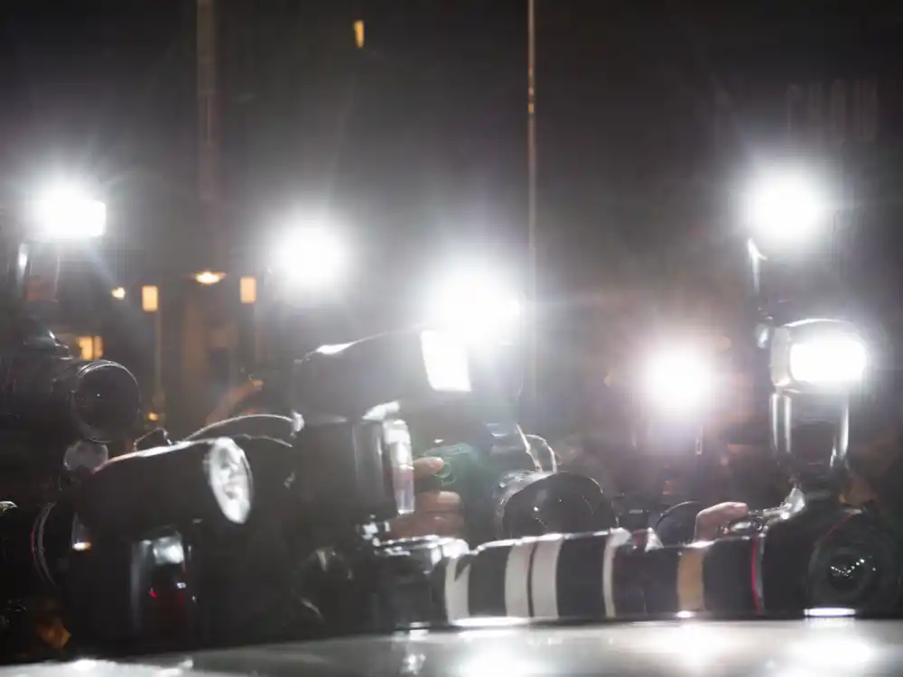 Celebrity splits 2026 paparazzi cameras and flash photography outside venue