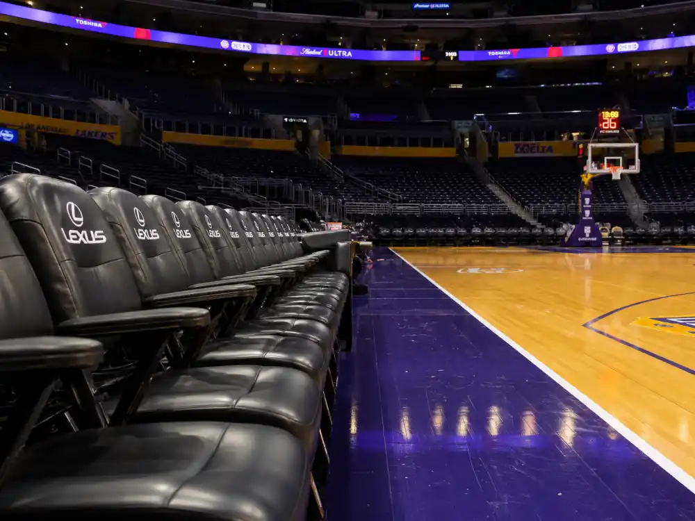 Empty VIP courtside seats at a basketball arena linked to Drake dating history and celebrity sightings