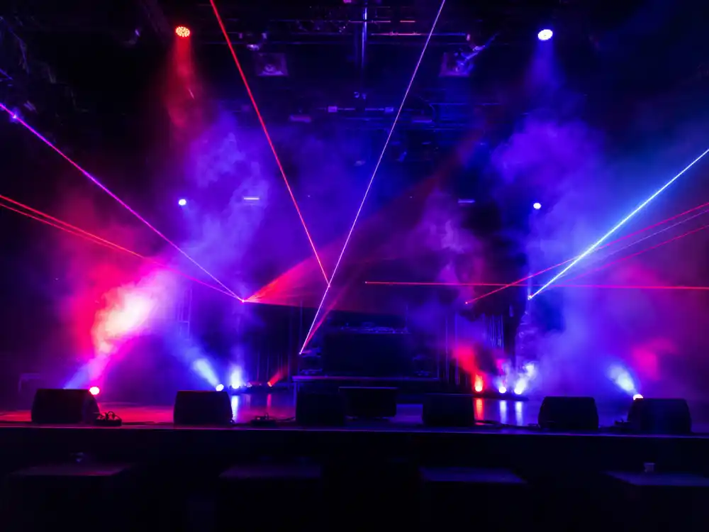 Hip-hop concert stage with dramatic smoke and laser effects during Drake girlfriend 2026 era touring