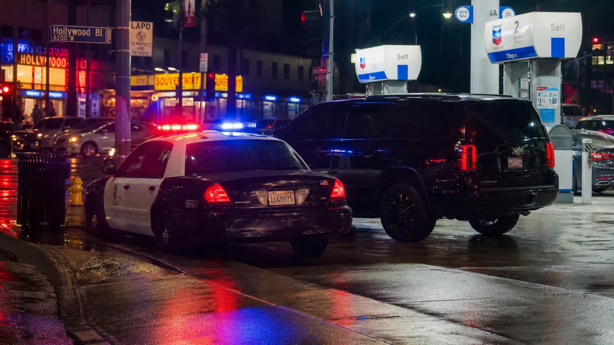 Police car with flashing lights at a Hollywood gas station similar to where Dwayne Johnson was pulled over for tinted windows