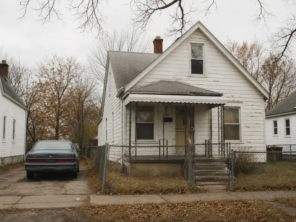 Modest white wood-frame Detroit bungalow on a working-class east-side street — the celebrity childhood home where Eminem grew up