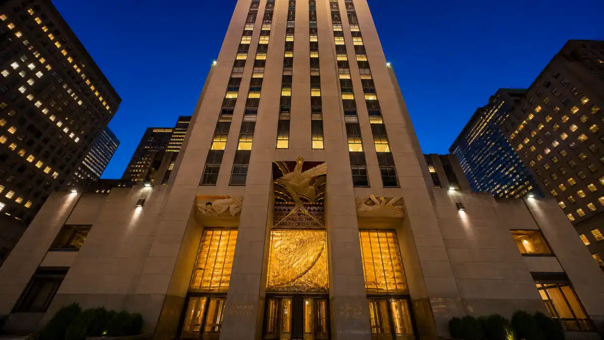 Art Deco skyscraper in midtown Manhattan at twilight where Emma Stone married Dave McCary nearby