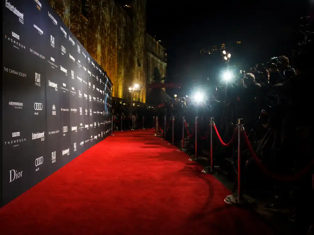 A glamorous film premiere red carpet scene with camera flashes capturing Florence Pugh boyfriend moments