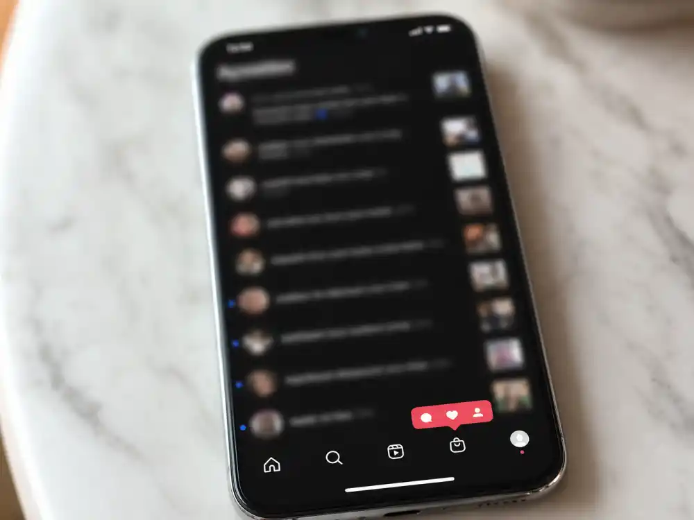Social media phone screen with blurred notifications reflecting Jenna Ortega dating history speculation online