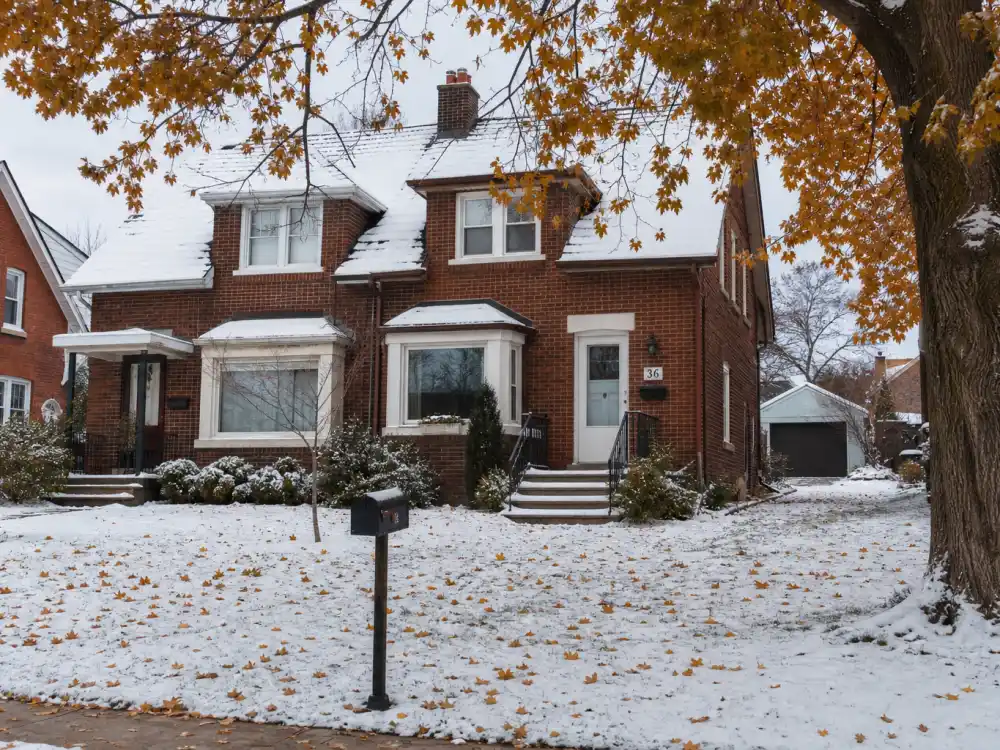 Modest red brick Canadian house with snow on the lawn in Stratford Ontario where Justin Bieber lived as a child before fame
