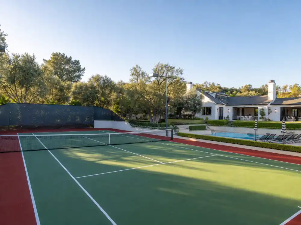 Tennis court and infinity pool inside a Hidden Hills mansion comparable to the Kylie Jenner Hidden Hills sale property