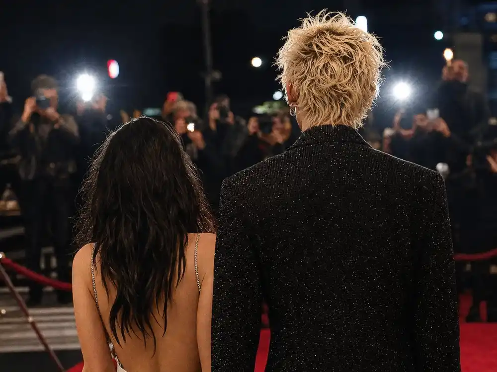 machine gun kelly megan fox 700 percent search spike may 2026 relationship rumors are represented by an anonymous couple facing paparazzi flashes.