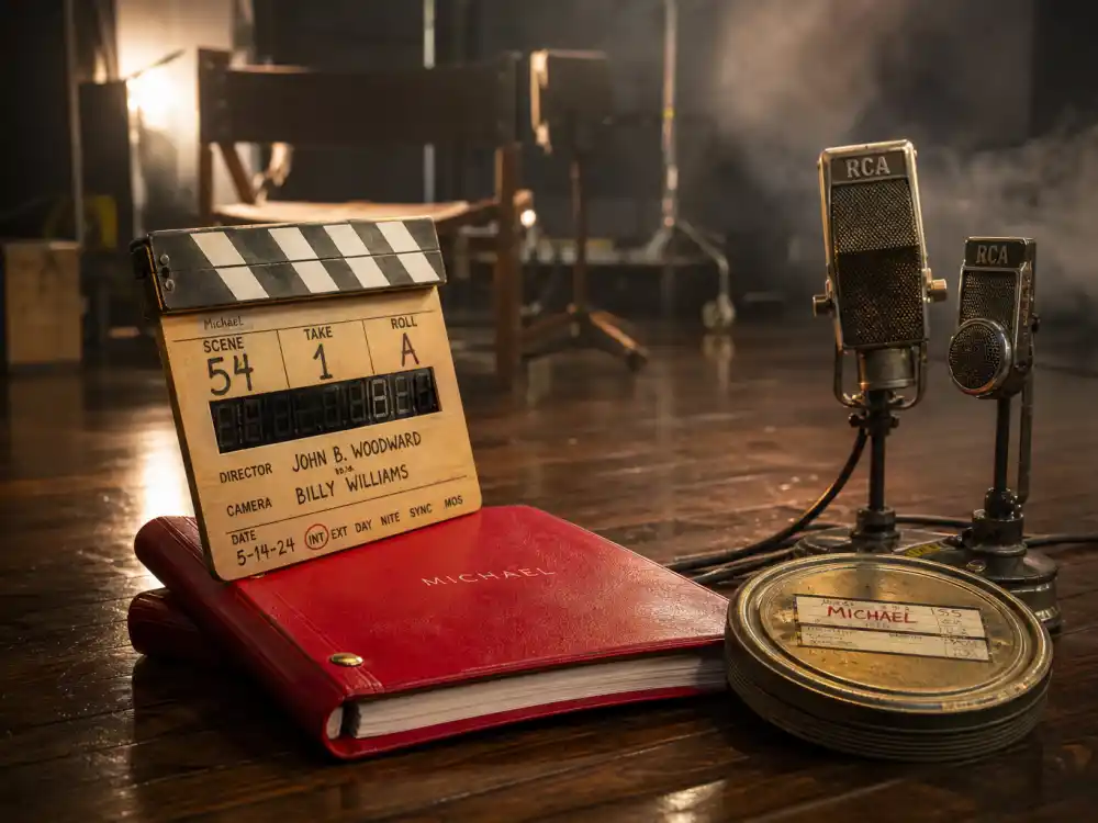 Hollywood film clapperboard and red bound script on a soundstage floor representing the Michael Jackson biopic that Janet Jackson declined to appear in