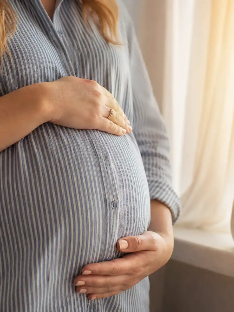 Natasha Bure pregnant announcement poster showing baby bump with Mama mug