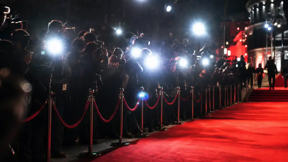 Red carpet event with paparazzi camera flashes celebrating new celebrity couples 2026