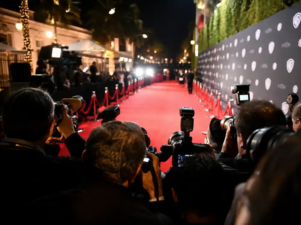 Paparazzi cameras at a red carpet event covering celebrity couples like Nicole Kidman and Keith Urban