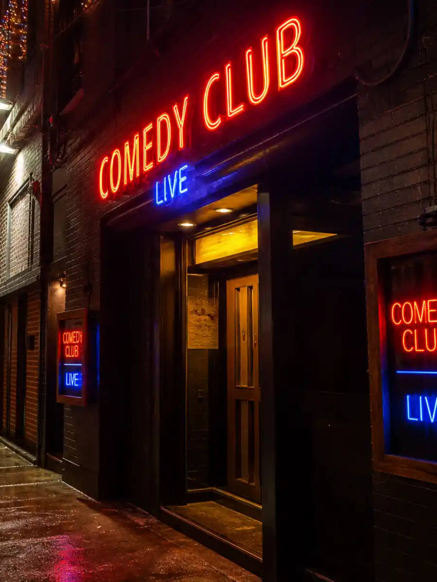 Neon comedy club sign representing Pete Davidson ex girlfriends web story poster