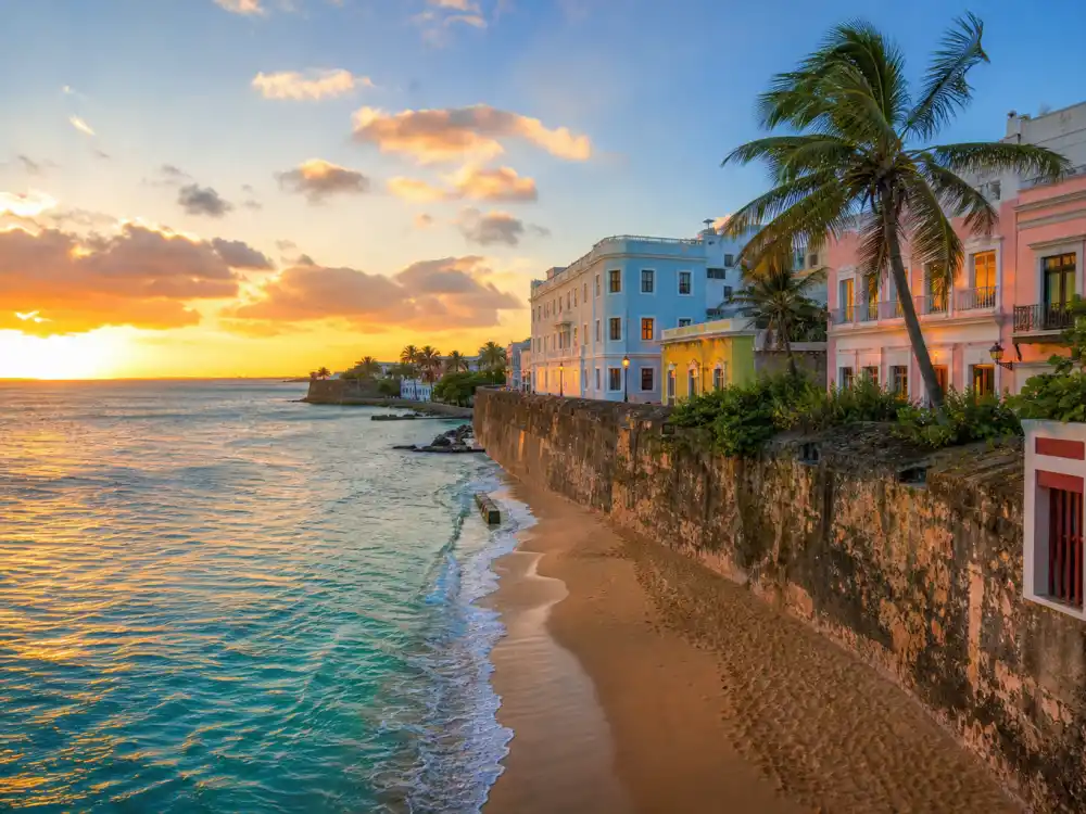 Puerto Rico beach sunset with colorful buildings near Bad Bunny dating history hometown