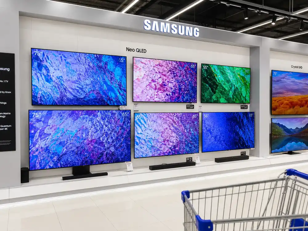 Samsung TV display wall in retail electronics store showing multiple screens