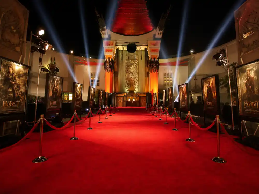 Hollywood movie premiere red carpet with spotlights, reminiscent of Scarlett Johansson husband Colin Jost attending her film events