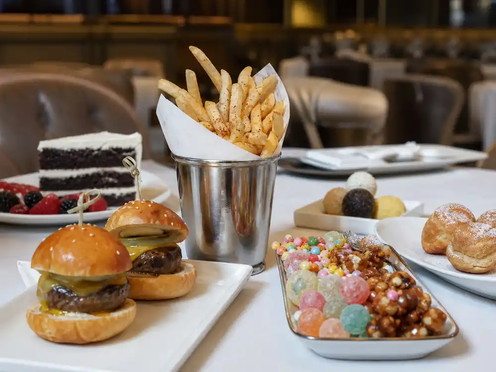 Benny Blanco junk food diet comments represented by an upscale dessert and snack table.