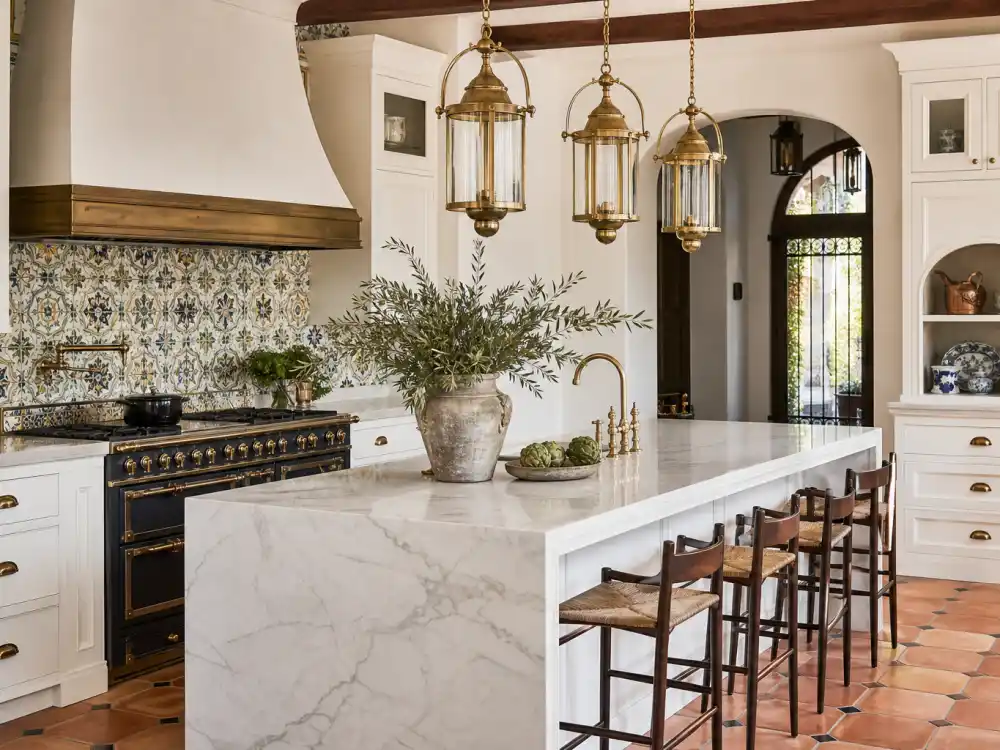 Calacatta marble kitchen with brass pendants and Talavera tile backsplash inside the Beverly Hills home where Selena Gomez lives