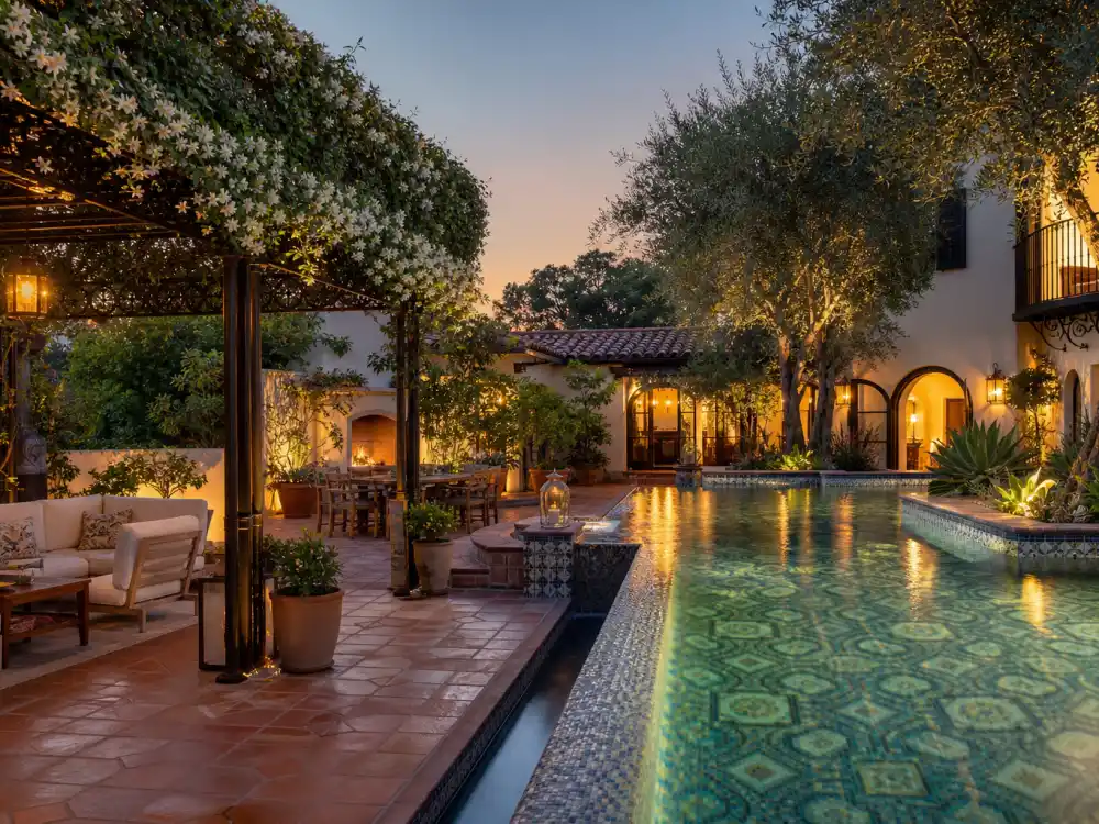 Mosaic tile infinity pool at twilight in the backyard of the Beverly Hills mansion where Selena Gomez lives