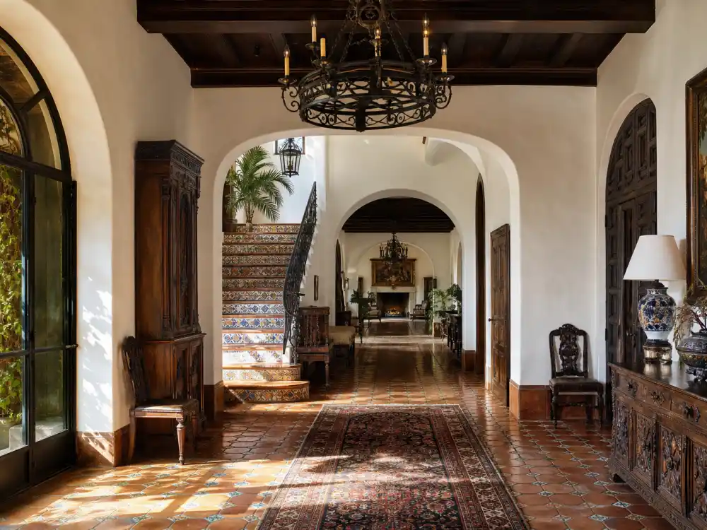 Hand-painted Saltillo tile foyer with iron chandelier and dark wood beams inside the Beverly Hills mansion where Selena Gomez lives