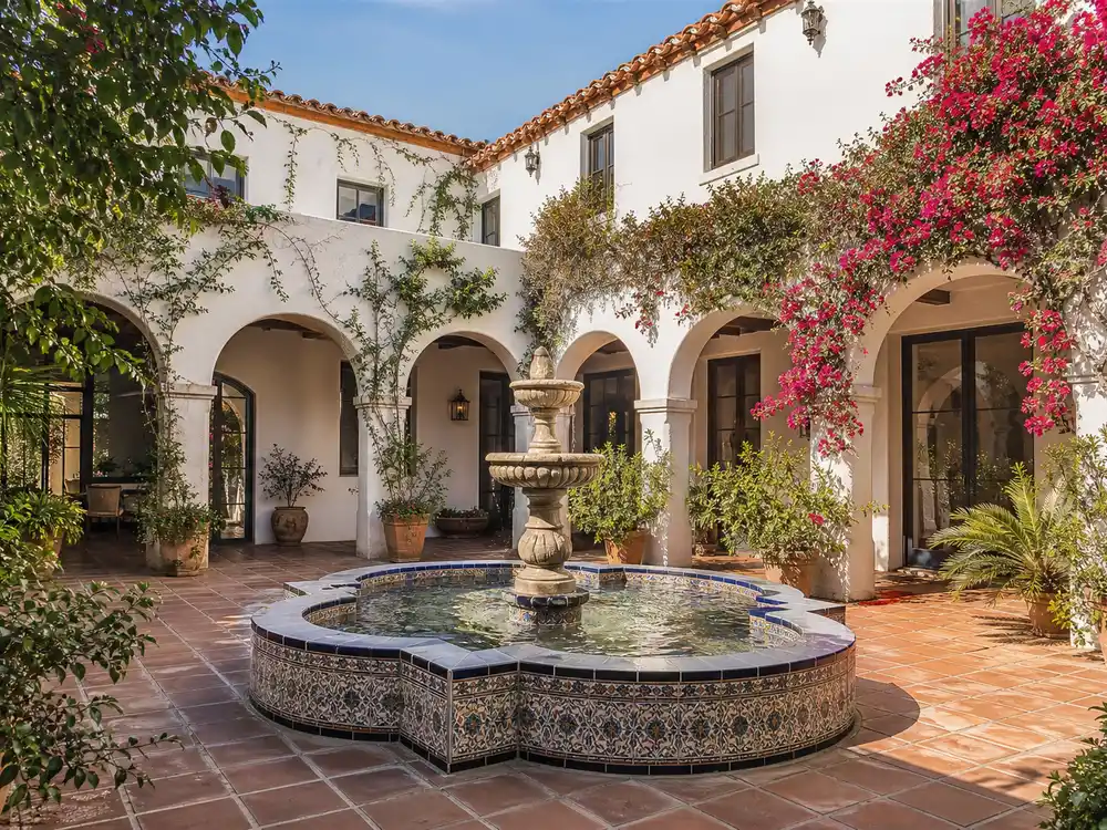 Selena Gomez house Beverly Hills tiled courtyard with central fountain and arched loggia