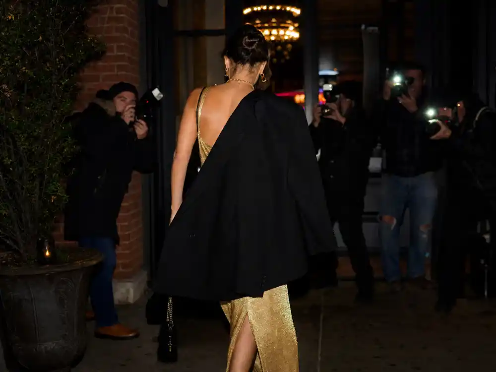 Blazer draped over shoulders visual for the Taylor Swift Travis Kelce NYC dinner exit.