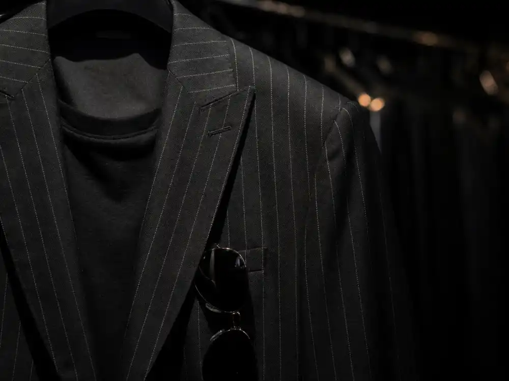 Black pinstriped suit detail for the Taylor Swift Travis Kelce NYC dinner style angle.