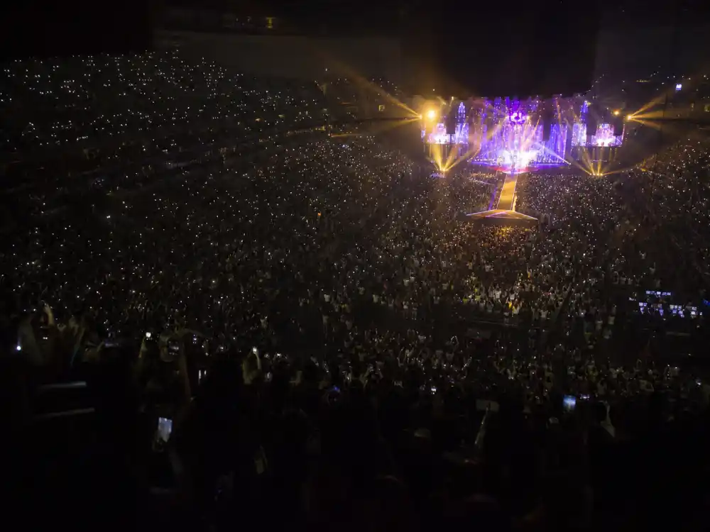 Packed concert arena with stage lights where Timothee Chalamet and Kylie Jenner were first spotted together