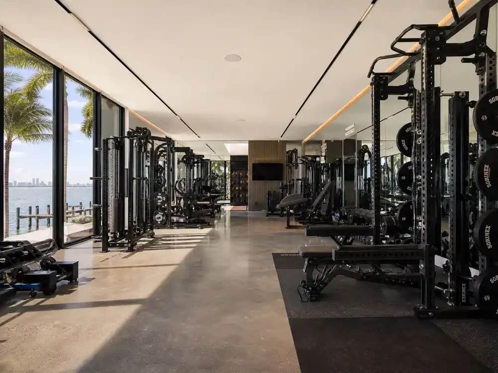 Tom Brady mansion Indian Creek private gym with NFL grade equipment overlooking bay