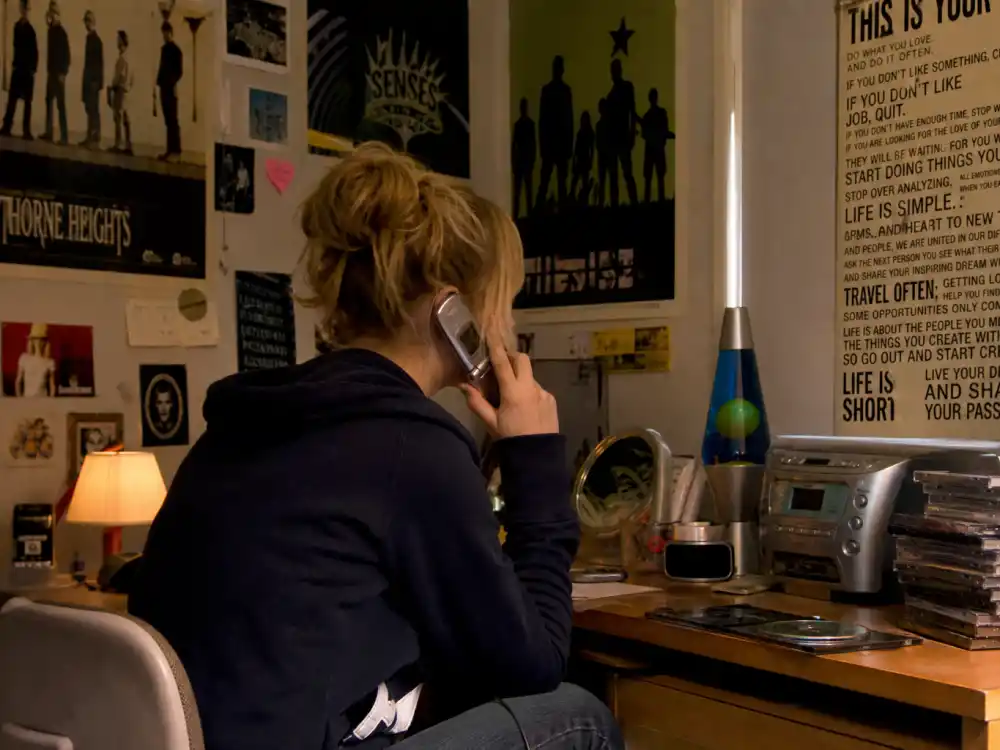 2000s teenage bedroom with posters and CD player evoking 2000s teen stars where are they now fandom