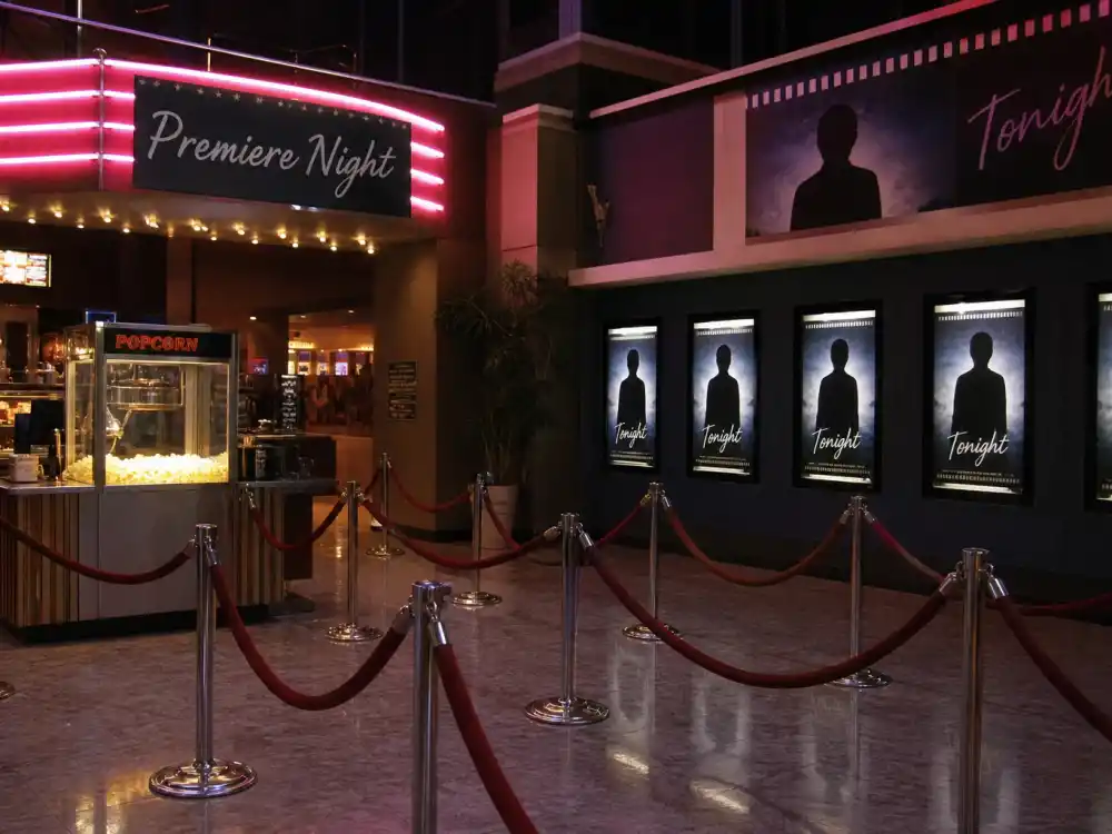 1990s multiplex movie theater lobby evoking 90s heartthrobs where are they now blockbuster premiere nights