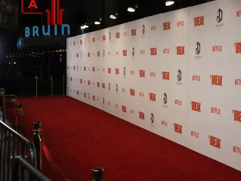 Empty 1990s Hollywood red carpet step-and-repeat evoking 90s heartthrobs where are they now premiere fame