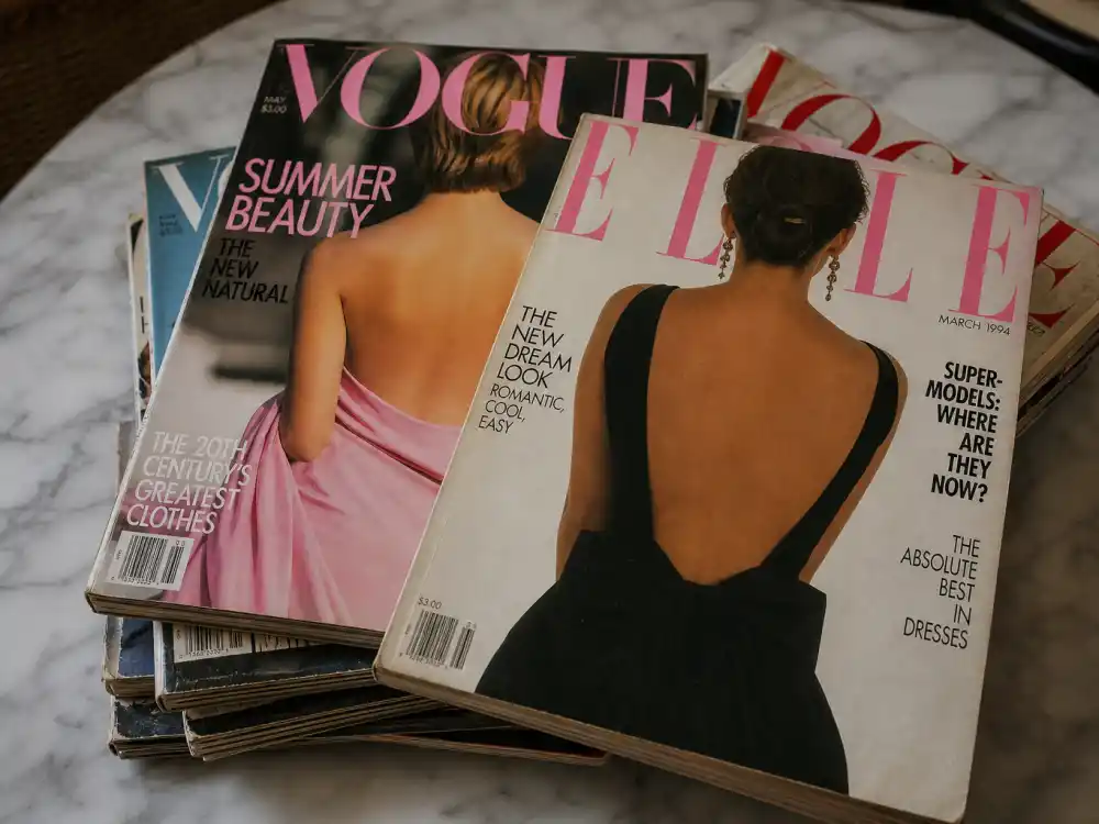 Stack of vintage 1990s fashion magazines representing the cover-girl era behind 90s supermodels where are they now searches
