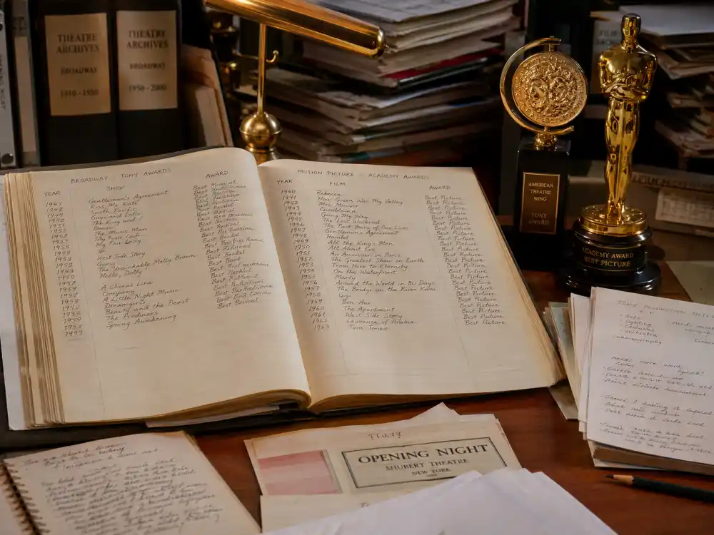 Theatre awards archive ledger beside Tony and Oscar statuettes listing verified actors who won both a Tony and an Oscar by category