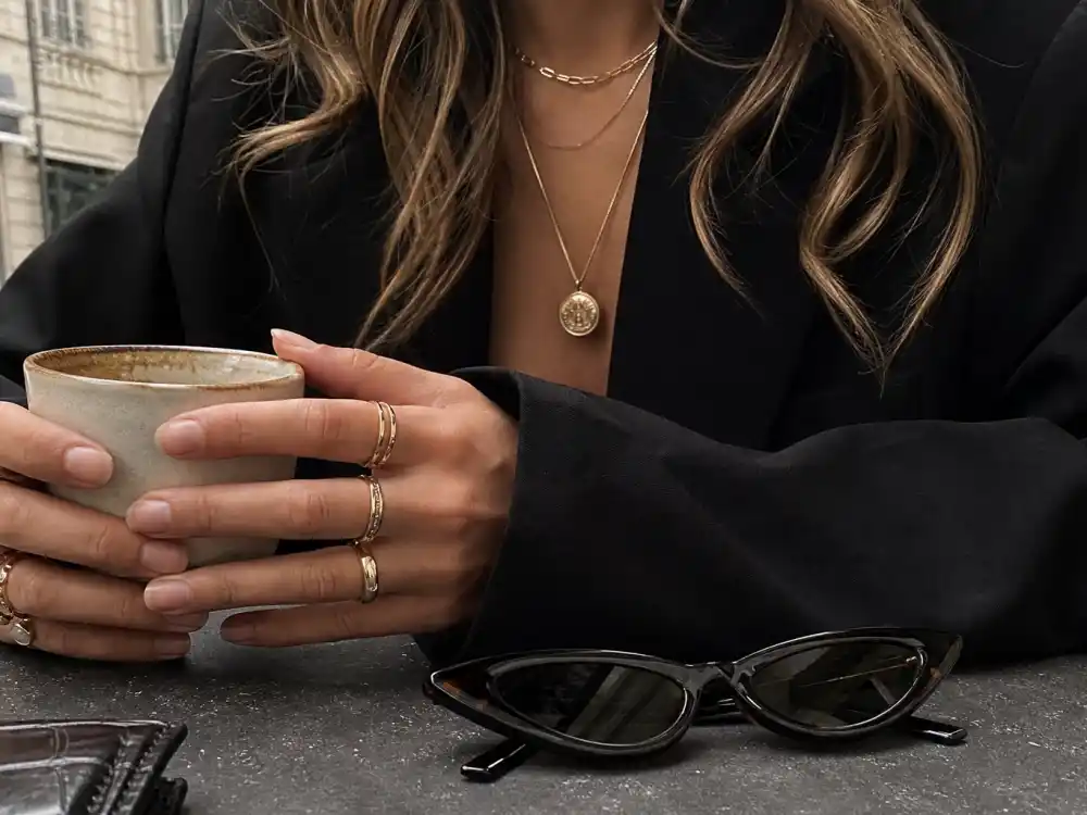 Layered delicate necklaces stacked rings and cat-eye sunglasses finishing Alexa Chung street style inspiration accessory layer