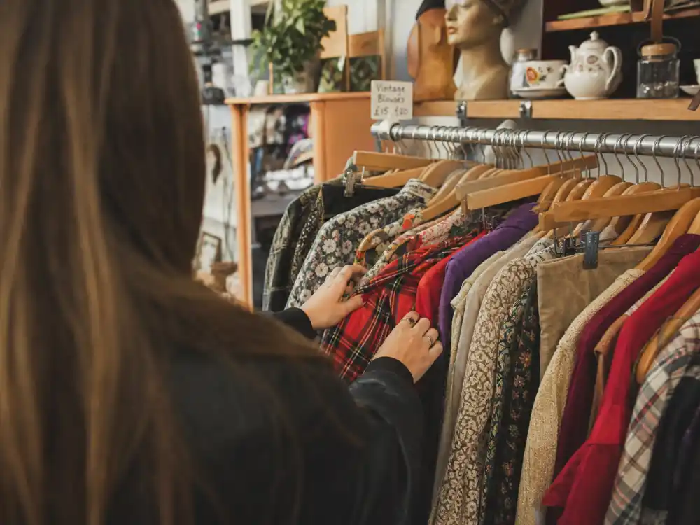 Vintage thrift boutique browsing racks behind Alexa Chung street style inspiration secondhand hunting philosophy