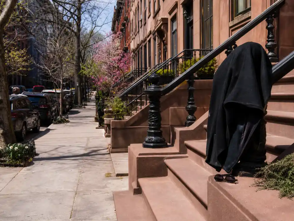 A Manhattan brownstone sidewalk scene for Ally Sheedy New York low-profile life in 2026