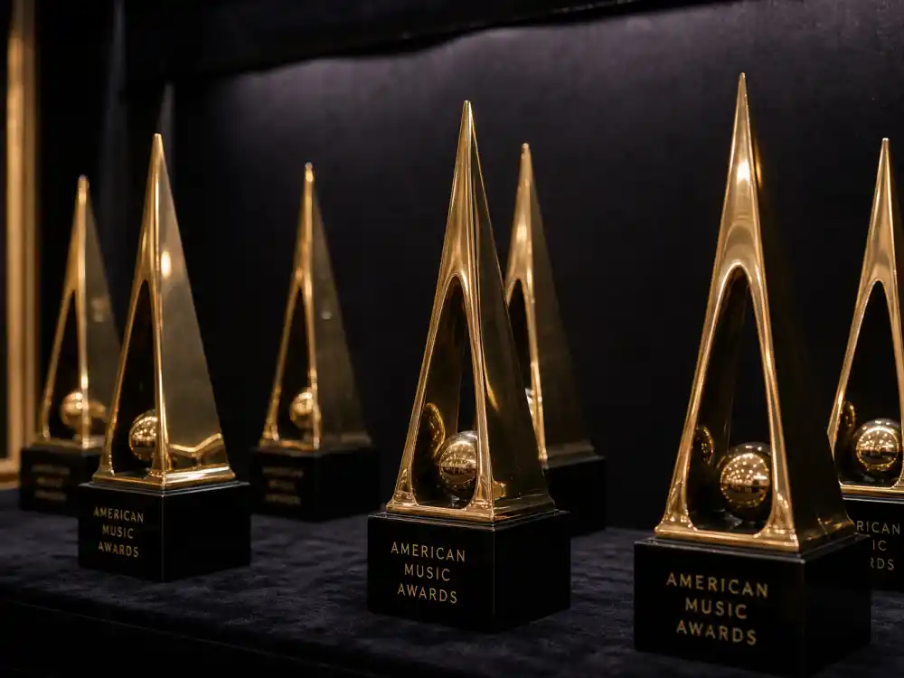 Golden American Music Awards trophy statuettes on velvet shelf representing decades of AMA Artist of the Year winners list history