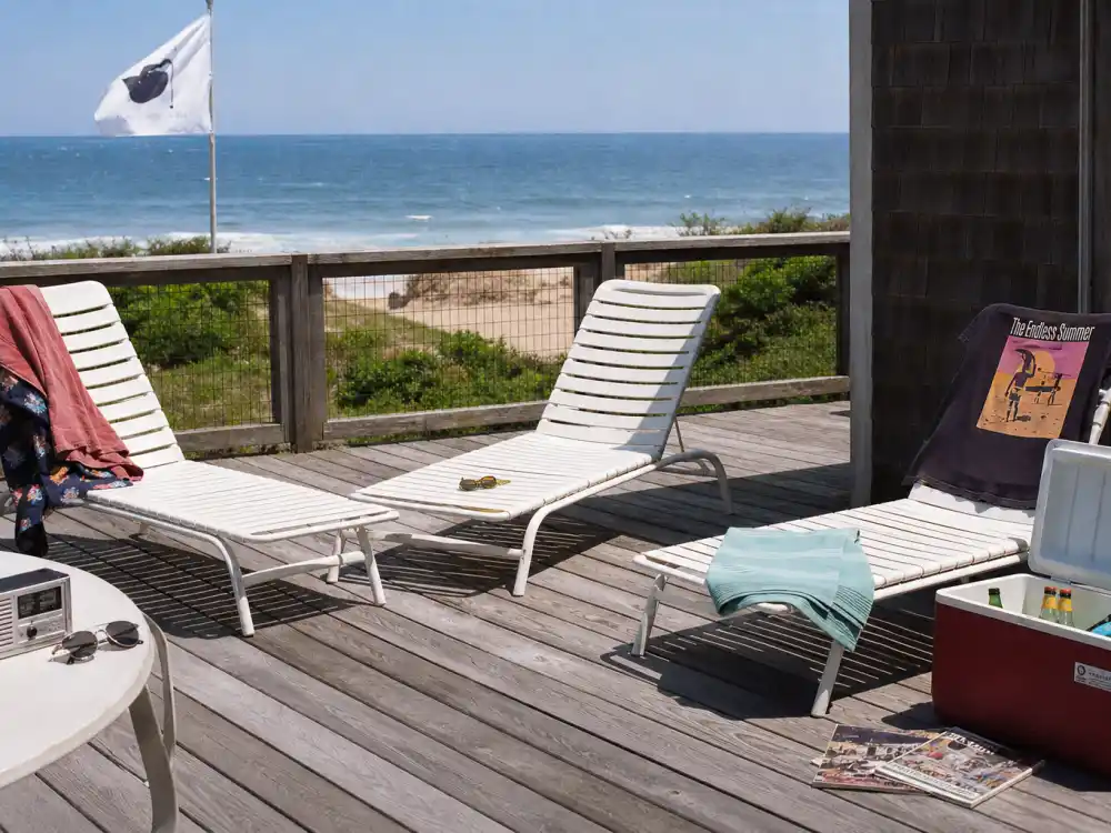 Hamptons beach house deck evoking Andrew McCarthy Weekend at Bernies comedy film peak