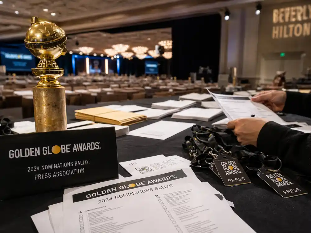 Golden Globes international voter ballots for are award shows rigged how voting works — trophy silhouette and press credential lanyards on table