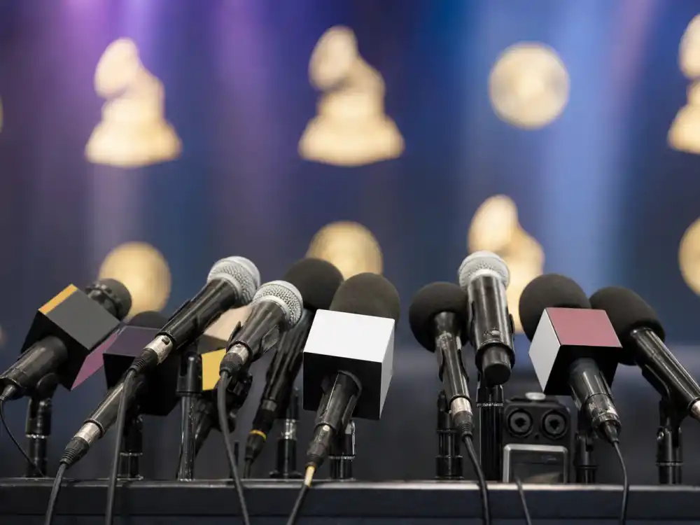 Leaderboard chart tracking artists with most Grammy nominations ever with generic golden trophies blurred in the foreground