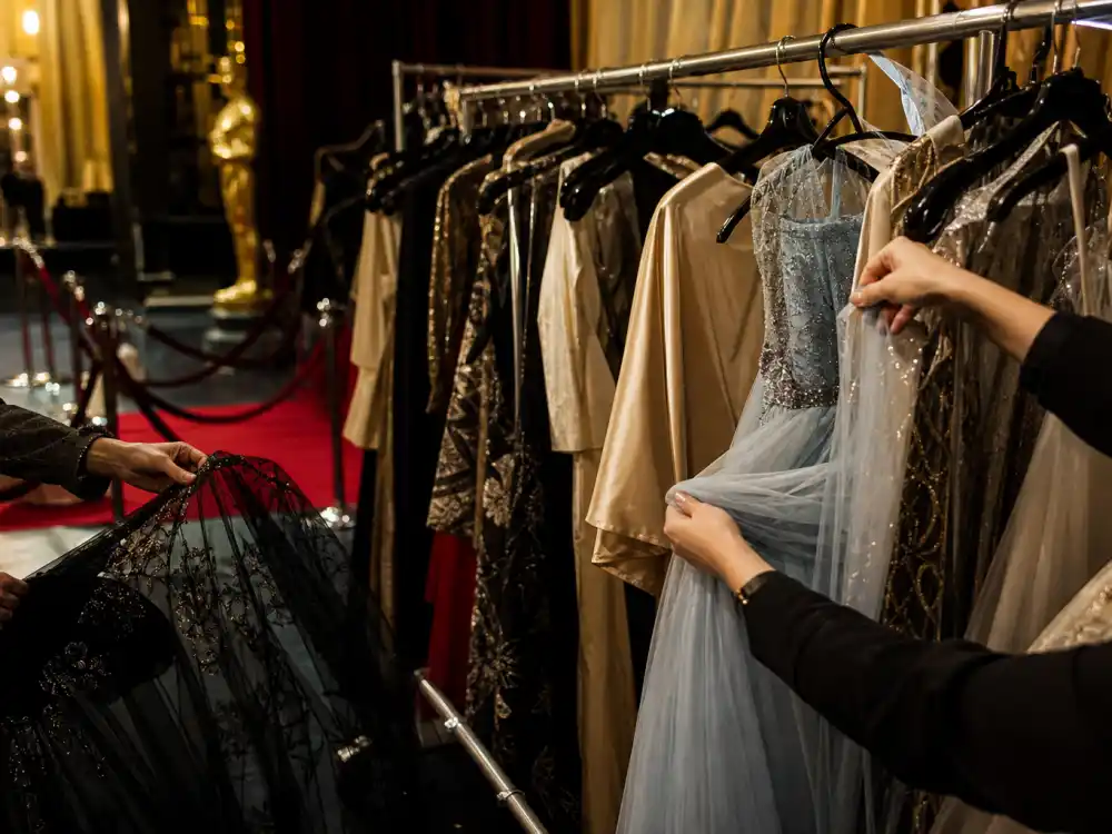 Backstage award show fashion trends 2026 wardrobe rack with formal evening gowns before red carpet arrivals at major ceremonies